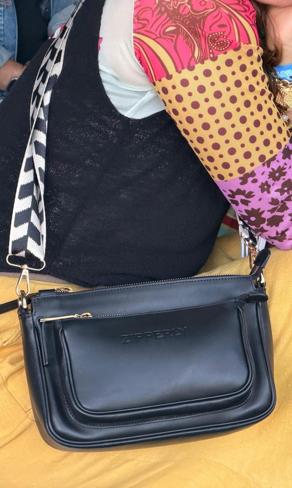 Black Italian leather Bag with colorful clothing background
