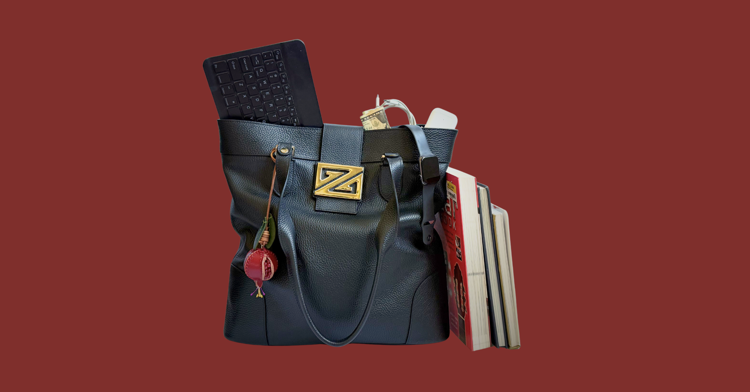 Black bag with various items on a red background